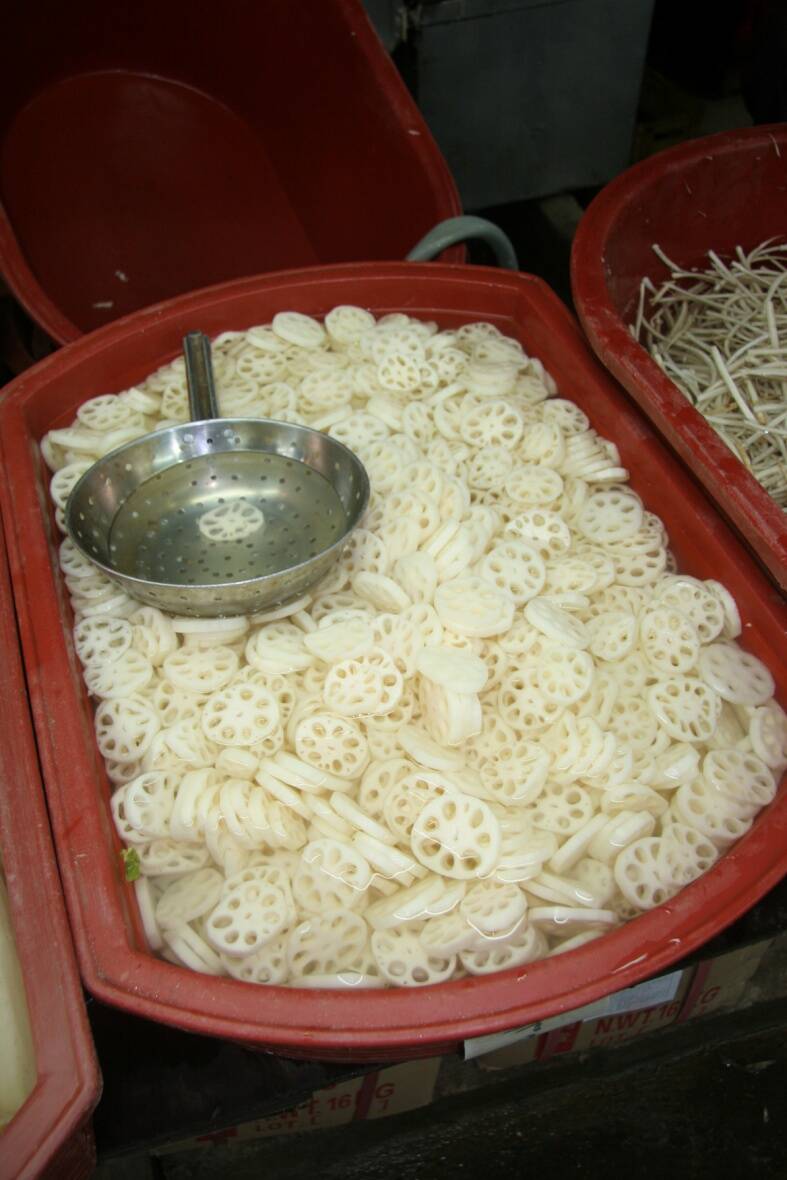 Photo of sliced lotus root with large arenchyma spaces.