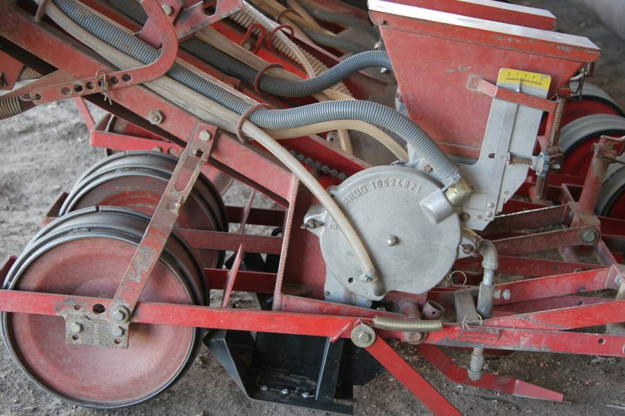 Detail photo of a mechanical field seeder.