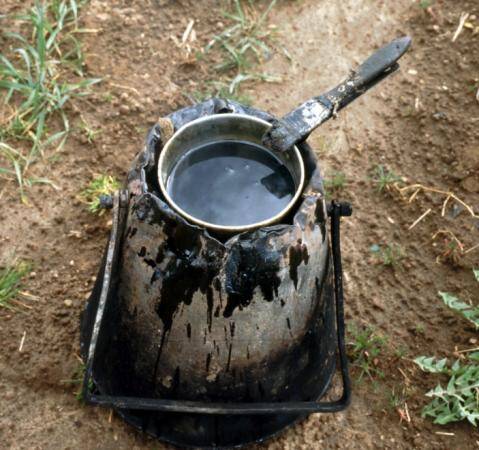 Photo of a pot of hot grafting wax being heated in the field.